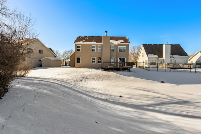 snow covered property featuring a deck