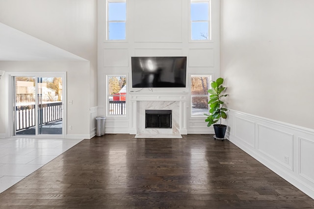 unfurnished living room with a fireplace and dark wood-type flooring