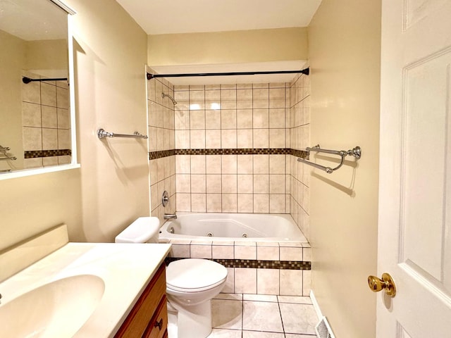 full bathroom with tile patterned floors, vanity, tiled shower / bath combo, and toilet