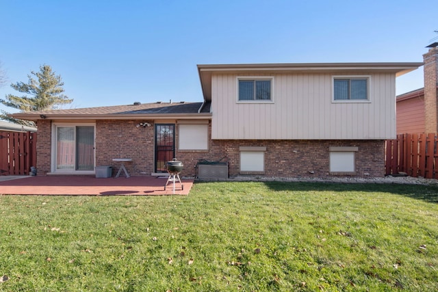 back of house with a lawn and a deck