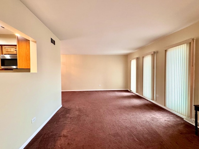 empty room with dark carpet