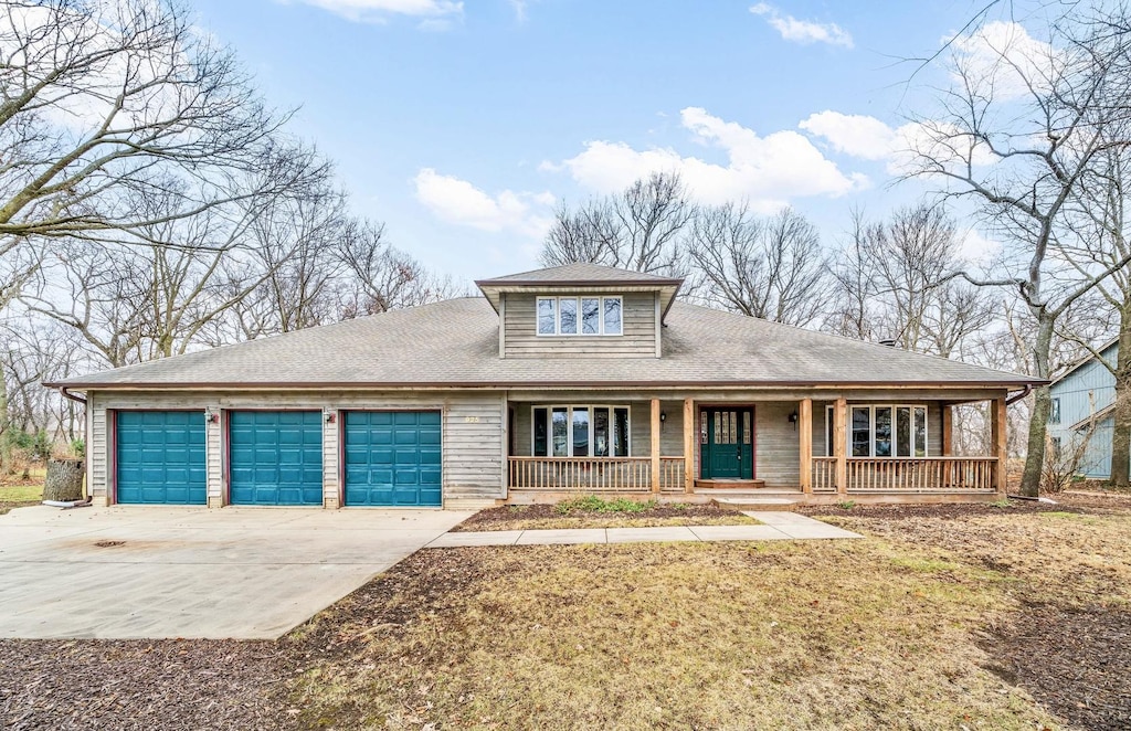 view of front of home featuring a porch and a garage