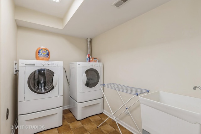 washroom featuring washer and dryer and sink