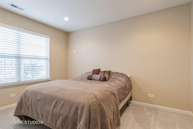 bedroom featuring light carpet