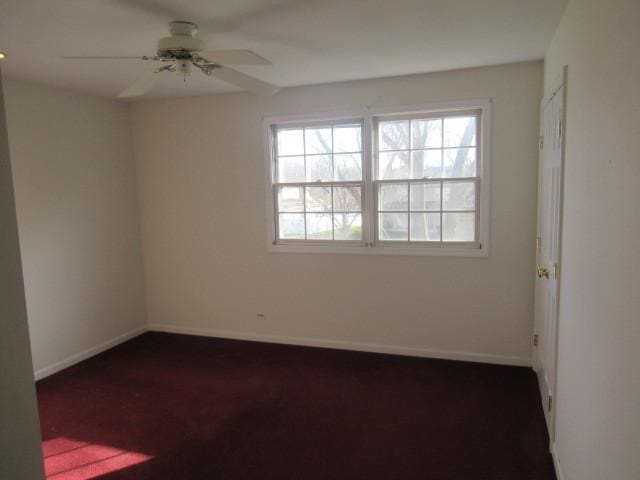 carpeted empty room featuring ceiling fan