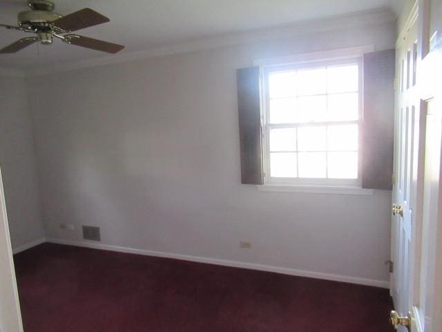 unfurnished room with ceiling fan, dark colored carpet, a healthy amount of sunlight, and ornamental molding