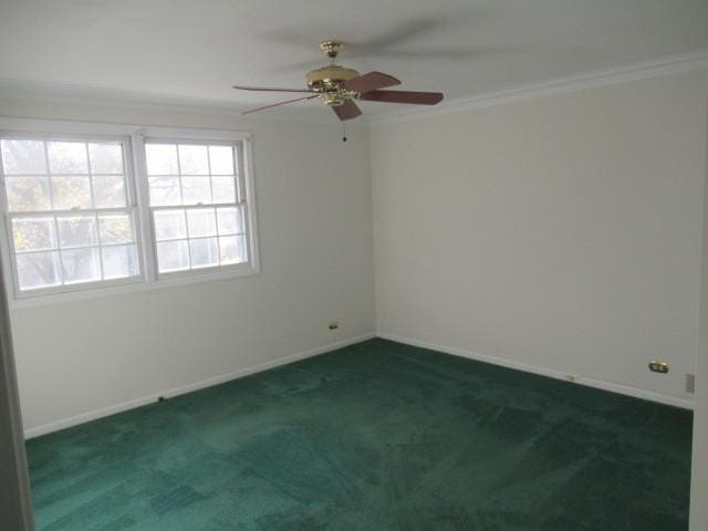 unfurnished room with crown molding, ceiling fan, and dark colored carpet