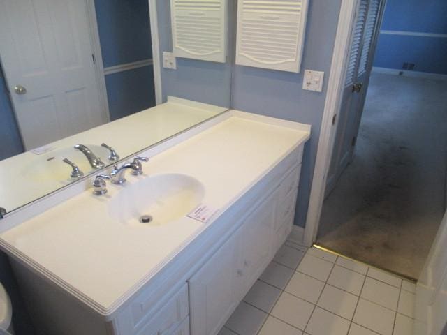 bathroom with tile patterned flooring and vanity