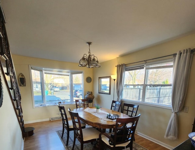 dining room featuring dark wood-type flooring and a notable chandelier