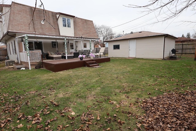 rear view of house featuring a yard, an outdoor living space, an outdoor structure, a wooden deck, and central AC unit