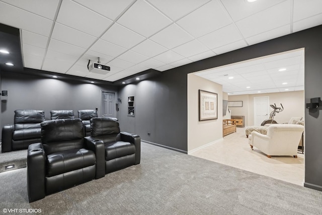 carpeted cinema featuring a paneled ceiling