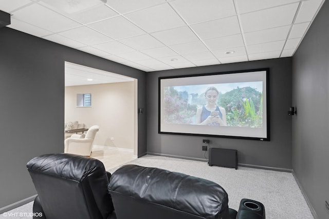 home theater room featuring carpet and a paneled ceiling