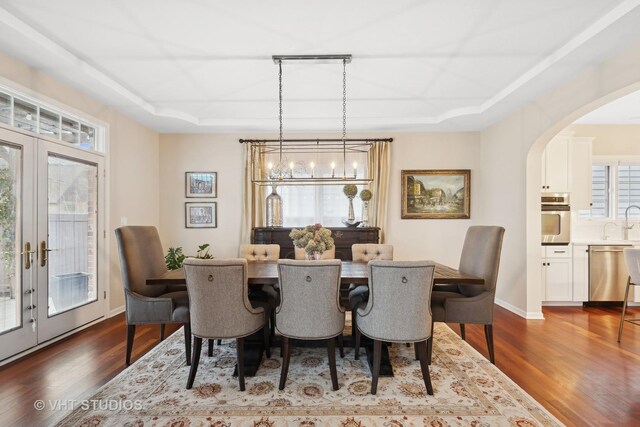 living room with an inviting chandelier, a fireplace, and dark hardwood / wood-style flooring