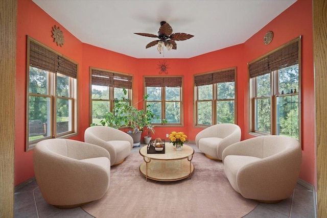 sunroom featuring a ceiling fan and a wealth of natural light