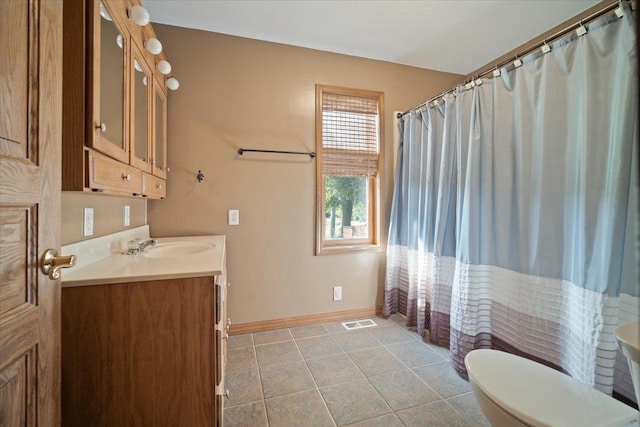 bathroom with visible vents, toilet, vanity, tile patterned flooring, and baseboards