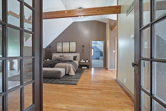 bedroom with high vaulted ceiling, light wood-type flooring, multiple windows, and baseboards