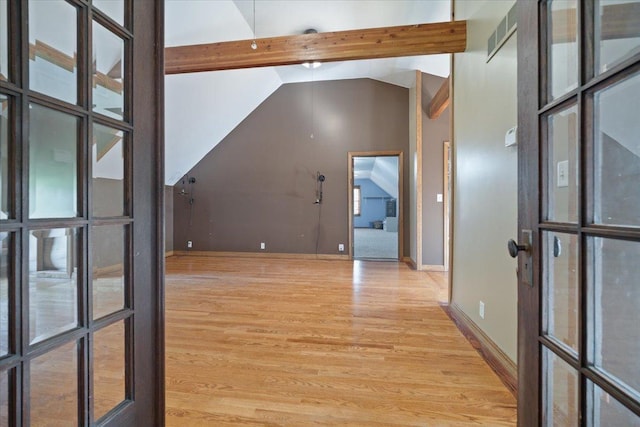 interior space featuring light wood-style floors, baseboards, high vaulted ceiling, and beamed ceiling