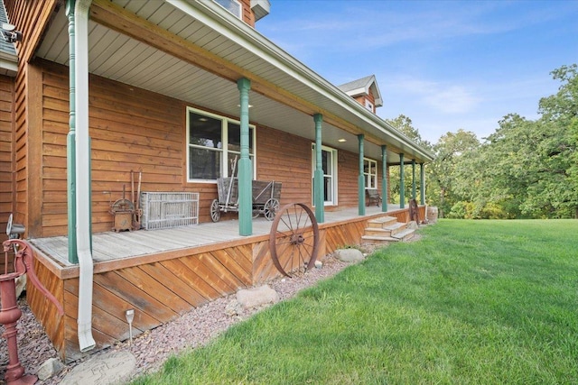 wooden deck with covered porch and a lawn