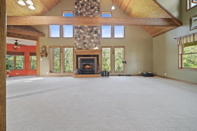 unfurnished living room featuring wood ceiling, a large fireplace, and carpet