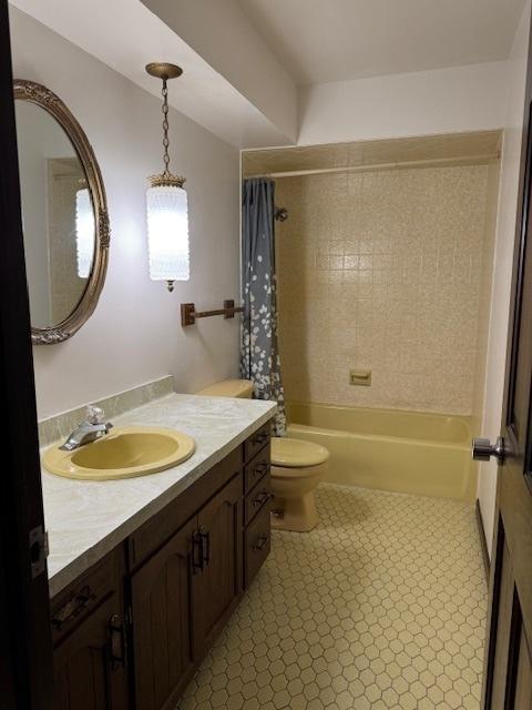 full bathroom featuring shower / bath combo, vanity, and toilet