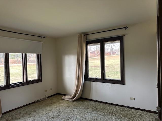 unfurnished room featuring light carpet