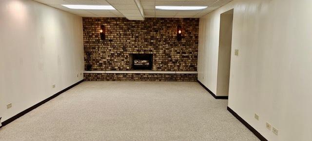 carpeted spare room with a drop ceiling