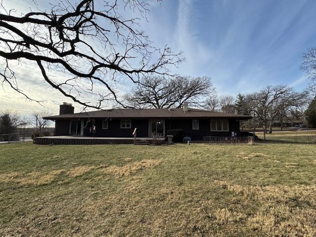 rear view of property with a lawn