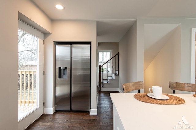 kitchen with dark hardwood / wood-style floors and stainless steel fridge with ice dispenser