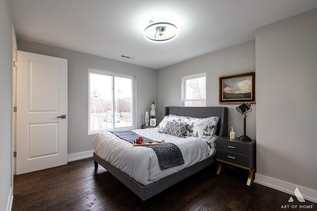 bedroom with dark wood-type flooring