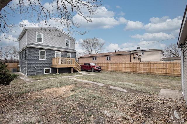 rear view of house featuring a wooden deck