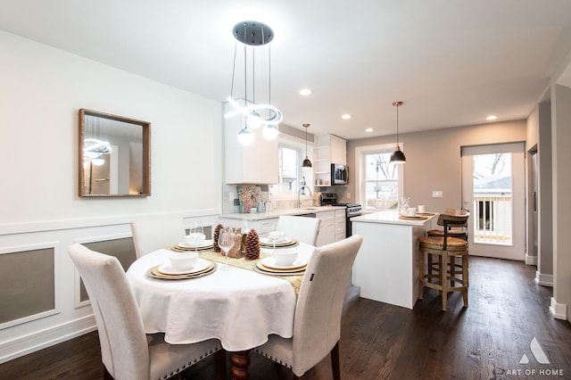 dining space with dark hardwood / wood-style flooring and sink