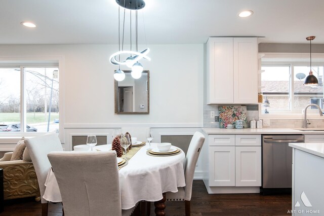 dining room with dark hardwood / wood-style floors, plenty of natural light, and sink