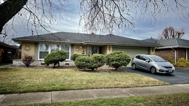 ranch-style home with a front lawn and a garage