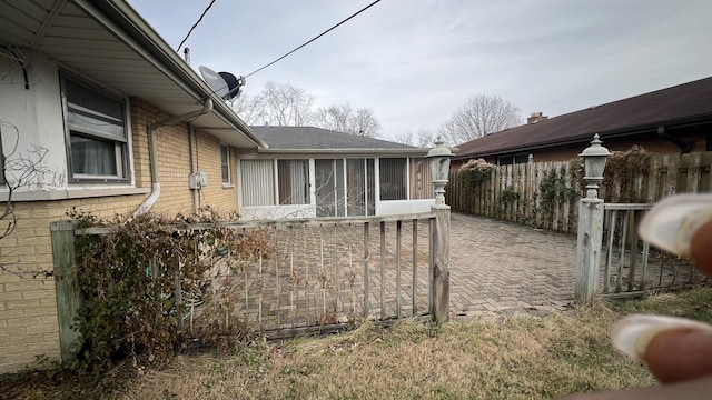 view of side of home featuring a sunroom