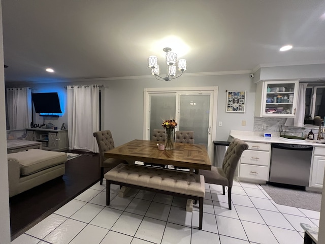 dining room with ornamental molding, light tile patterned floors, and a notable chandelier