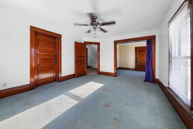 unfurnished bedroom featuring light colored carpet, ceiling fan, and a closet