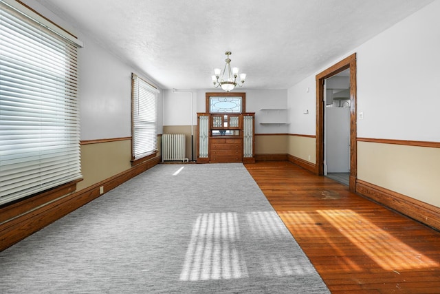 interior space with an inviting chandelier, radiator, and light wood-type flooring