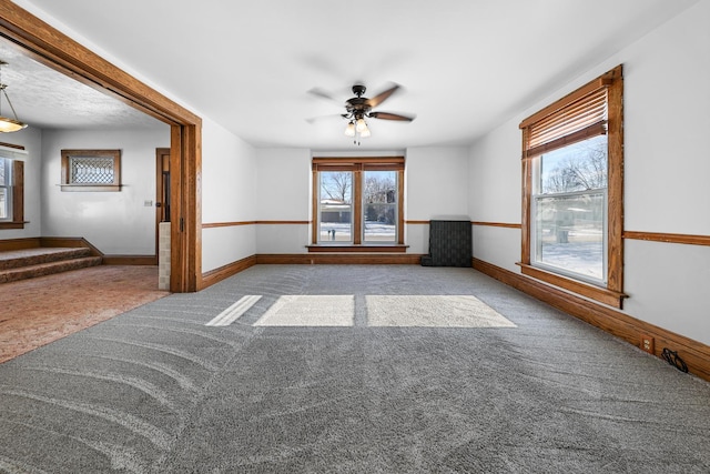 unfurnished room featuring light carpet and ceiling fan