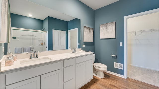 14824 S Dyer Ln, Plainfield, IL 60544 - bathroom with a shower stall, wood finished floors, double vanity, and a walk in closet