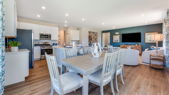 dining space with light hardwood / wood-style floors