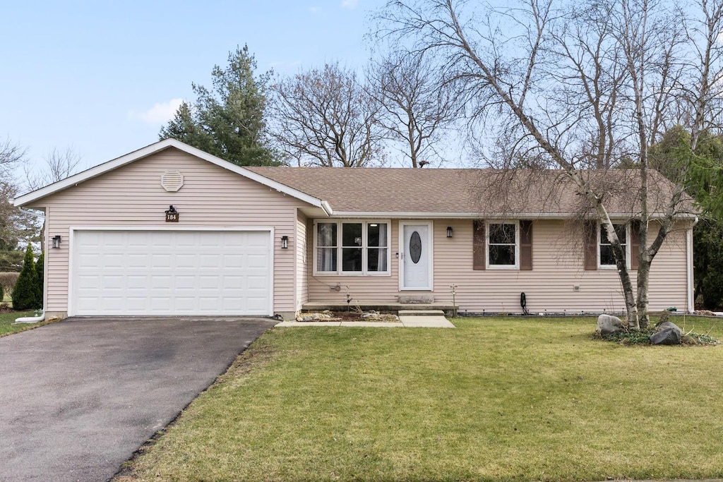 single story home with a front yard and a garage