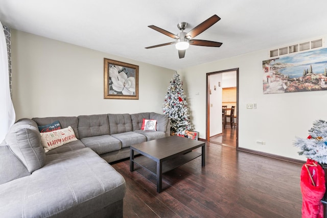 living room with dark hardwood / wood-style flooring and ceiling fan