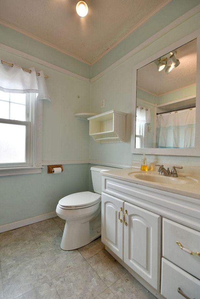 bathroom featuring vanity, tile patterned flooring, ornamental molding, and toilet