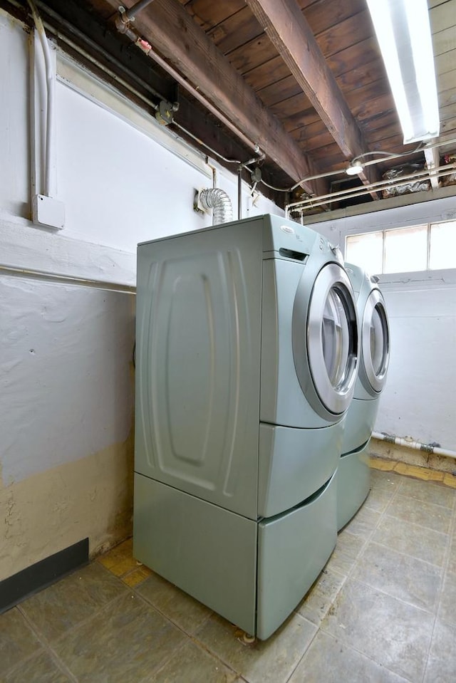 washroom with washing machine and dryer and wooden ceiling