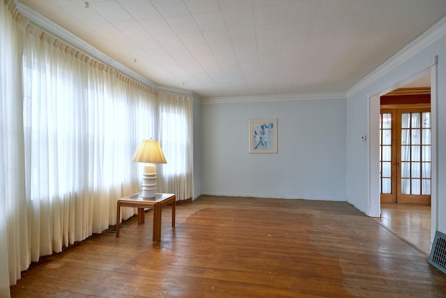 spare room featuring crown molding and hardwood / wood-style floors