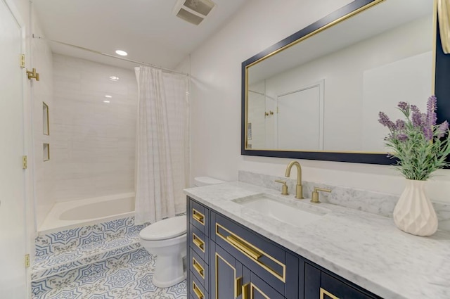 full bathroom with tile patterned flooring, shower / bath combo with shower curtain, vanity, and toilet