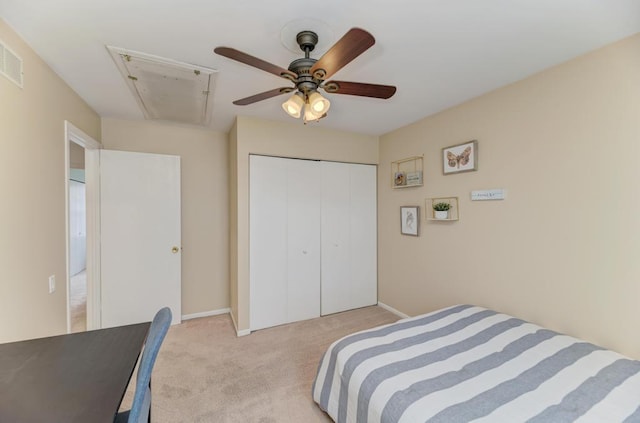 bedroom with a closet, ceiling fan, and light colored carpet