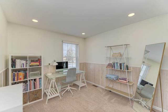 carpeted office featuring wooden walls