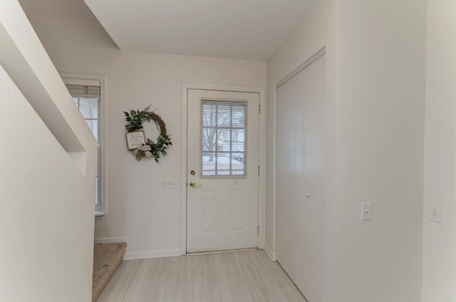 doorway with a healthy amount of sunlight and light wood-type flooring