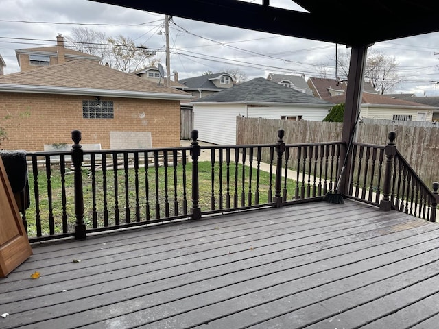 wooden deck featuring a lawn